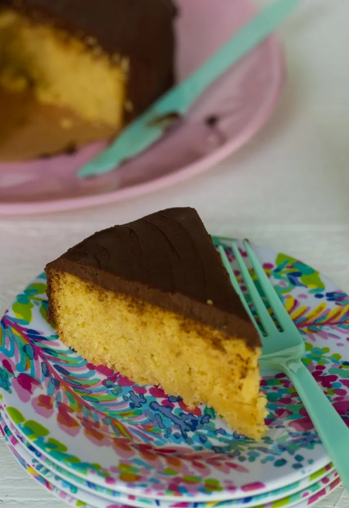 Buttery keto yellow cake with fudgey chocolate frosting is just like a boxed mix but sugar free, gluten free, and only 2 carbs per piece!