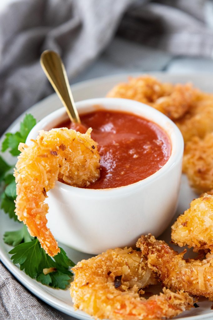 Basic low carb ingredients and 20 minutes are all you need for these low carb coconut fried shrimp. A recipe for sugar free cocktail sauce is included too! 