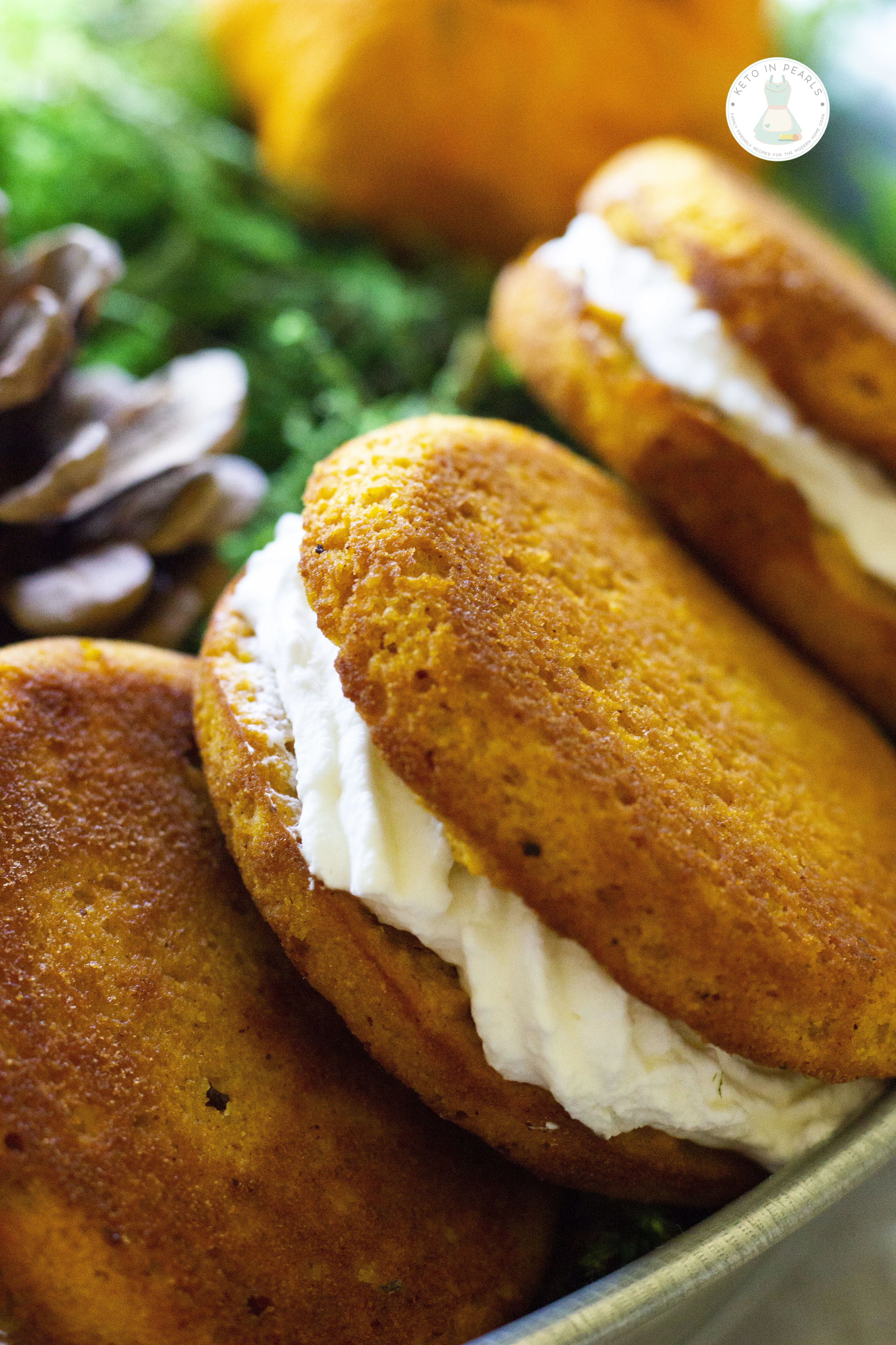 A keto pumpkin roll in handheld form! These keto pumpkin spice whoopee pies are low in carbs, easy to bake, and perfect for carrying to the pumpkin patch! 