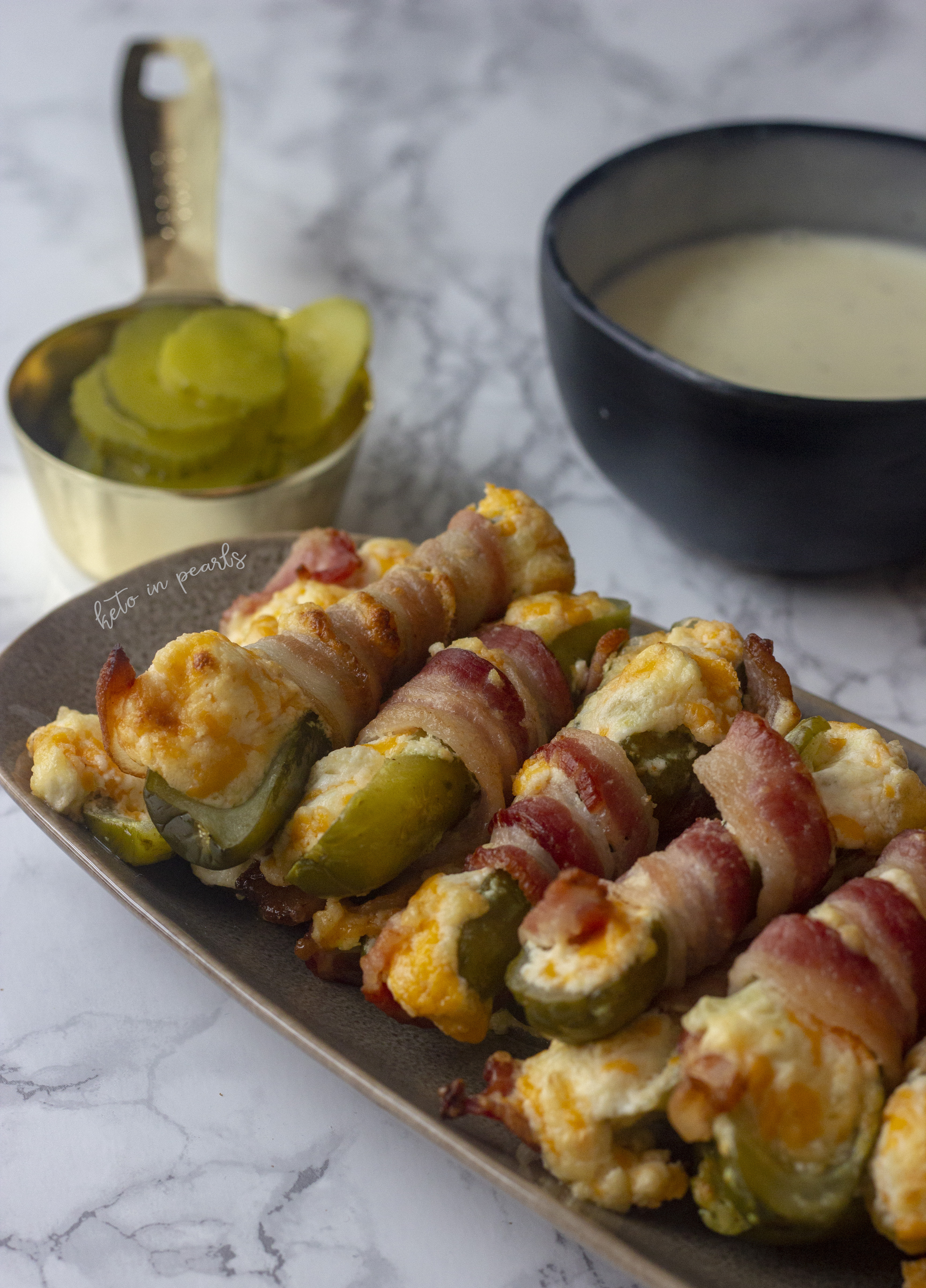 A salty, cheesy, and bacon-y zero carb appetizer. Bacon Wrapped Pickle Poppers are the perfect keto snacks for a keto Super Bowl party. 