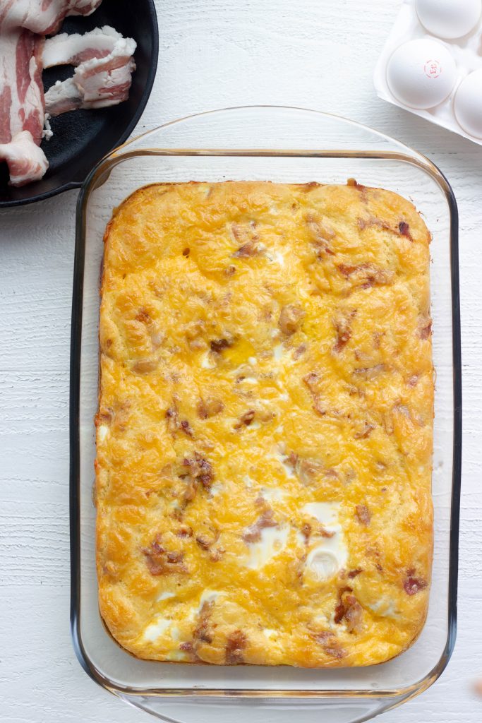A keto breakfast casserole with bacon, sausage, egg, cheese, and a buttery keto friendly bread. Perfect for meal prep and just 3.5 net carbs per serving!