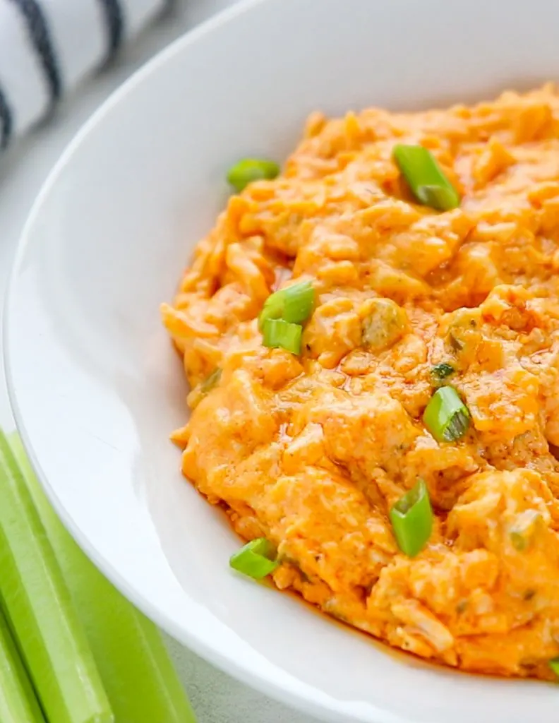 Baked keto buffalo chicken dip with jalapeÃ±o and green onion.