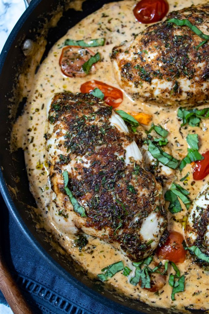 Italian marinated chicken breasts that are baked then topped in a balsamic and herb cream sauce with fresh basil and tomatoes. This easy bruschetta chicken recipe is easy enough for a weeknight dinner and impressive enough for a dinner party.