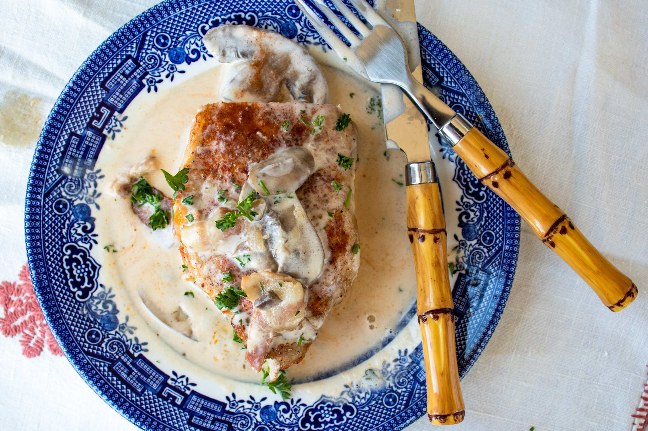 Baked boneless pork chops smothered with bacon and mushroom cream sauce.