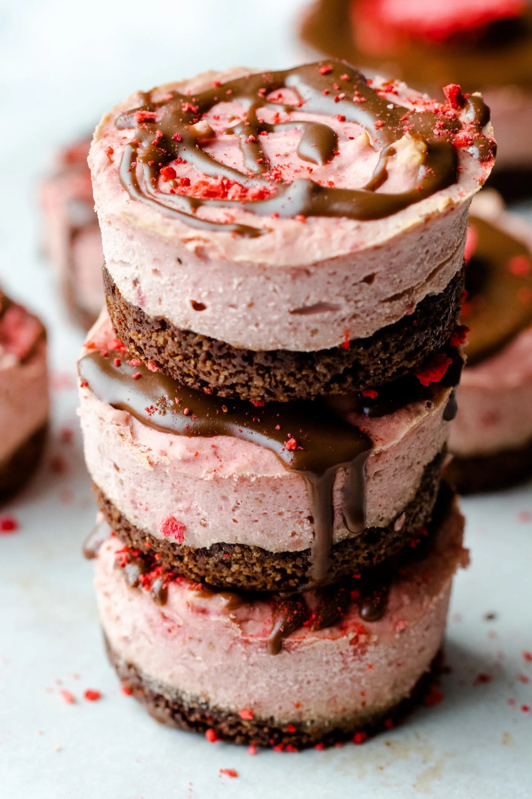 Stack of chocolate covered strawberry low carb cheesecakes.