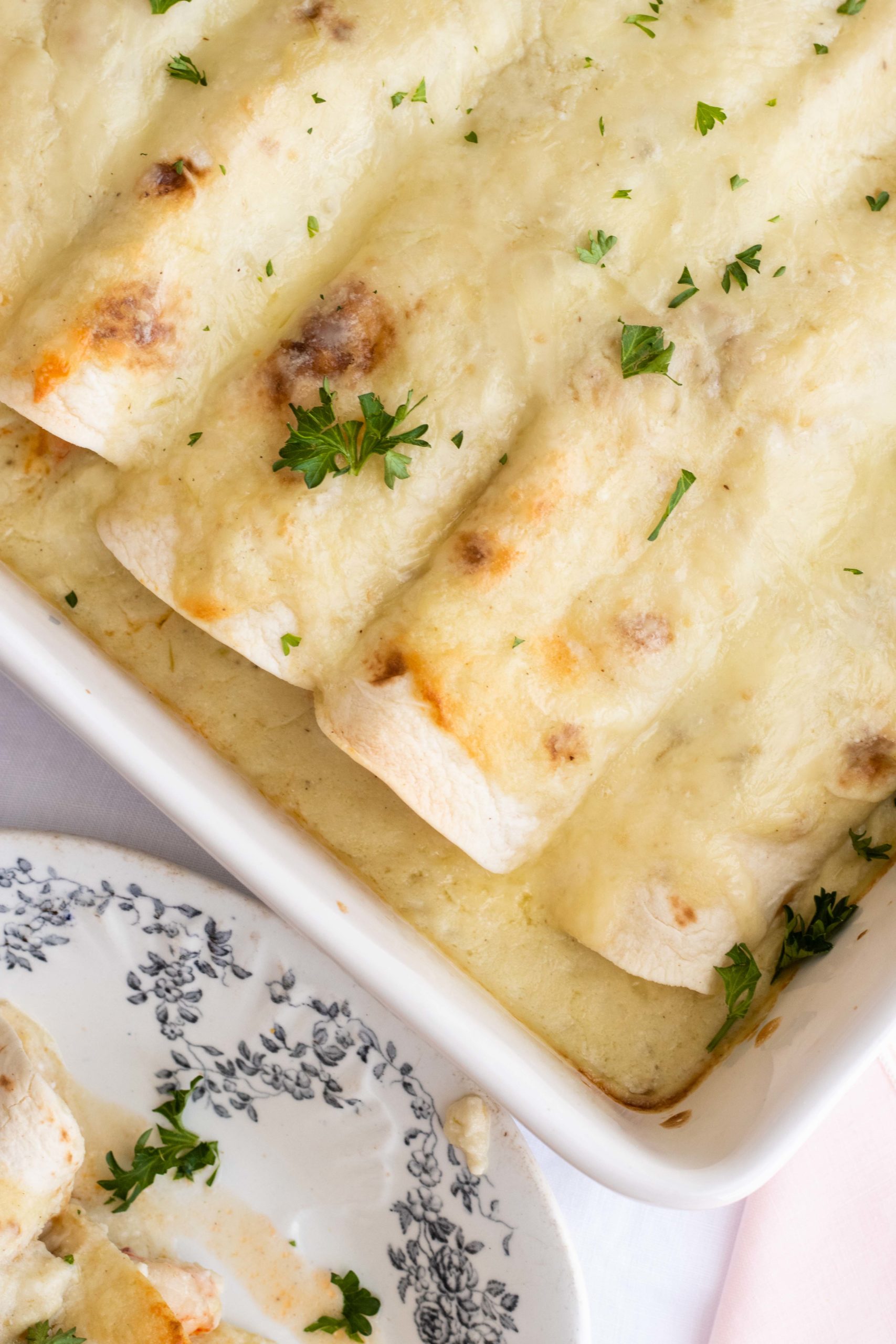 Shrimp enchiladas wrapped in low carb tortillas with creamy Monterey Jack cheese sauce.