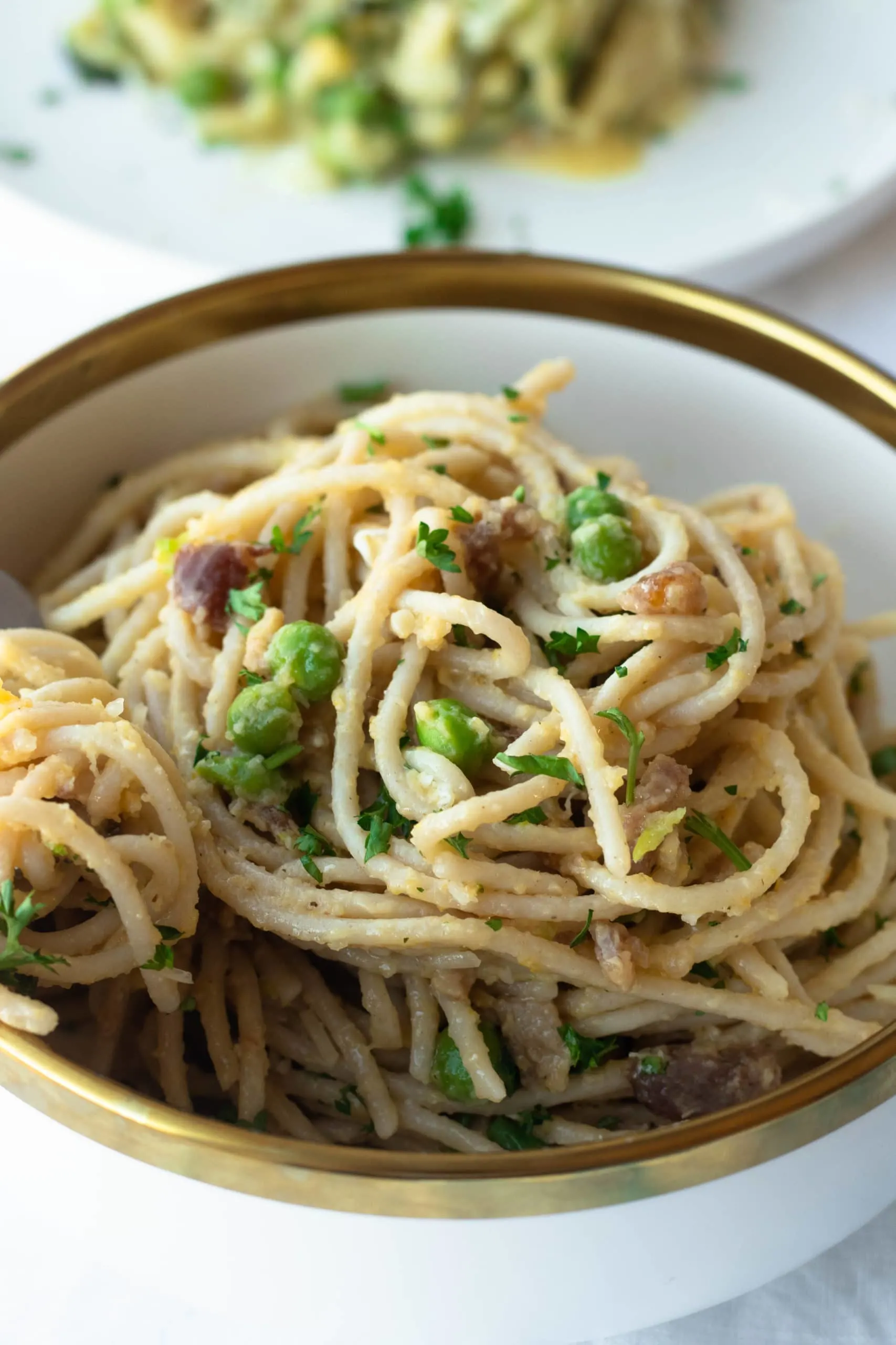 Classic carbonara pasta is transformed into a healthy, gluten free, and low carb pasta recipe. Parmesan cheese, peas, bacon, and browned butter adorn your choice of low carb noodles or zucchini noodles. This decadent keto carbonara will make you forget you're eating healthy!