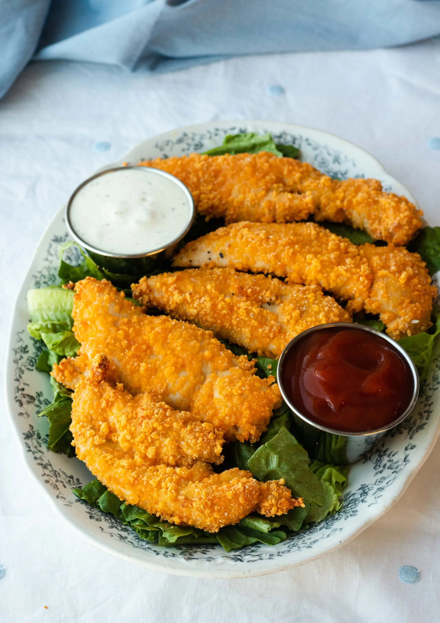 Chicken tenders are brined in buttermilk and then breaded in a crunchy cheese breading before getting baked to perfection. No eggs or pork rinds required!