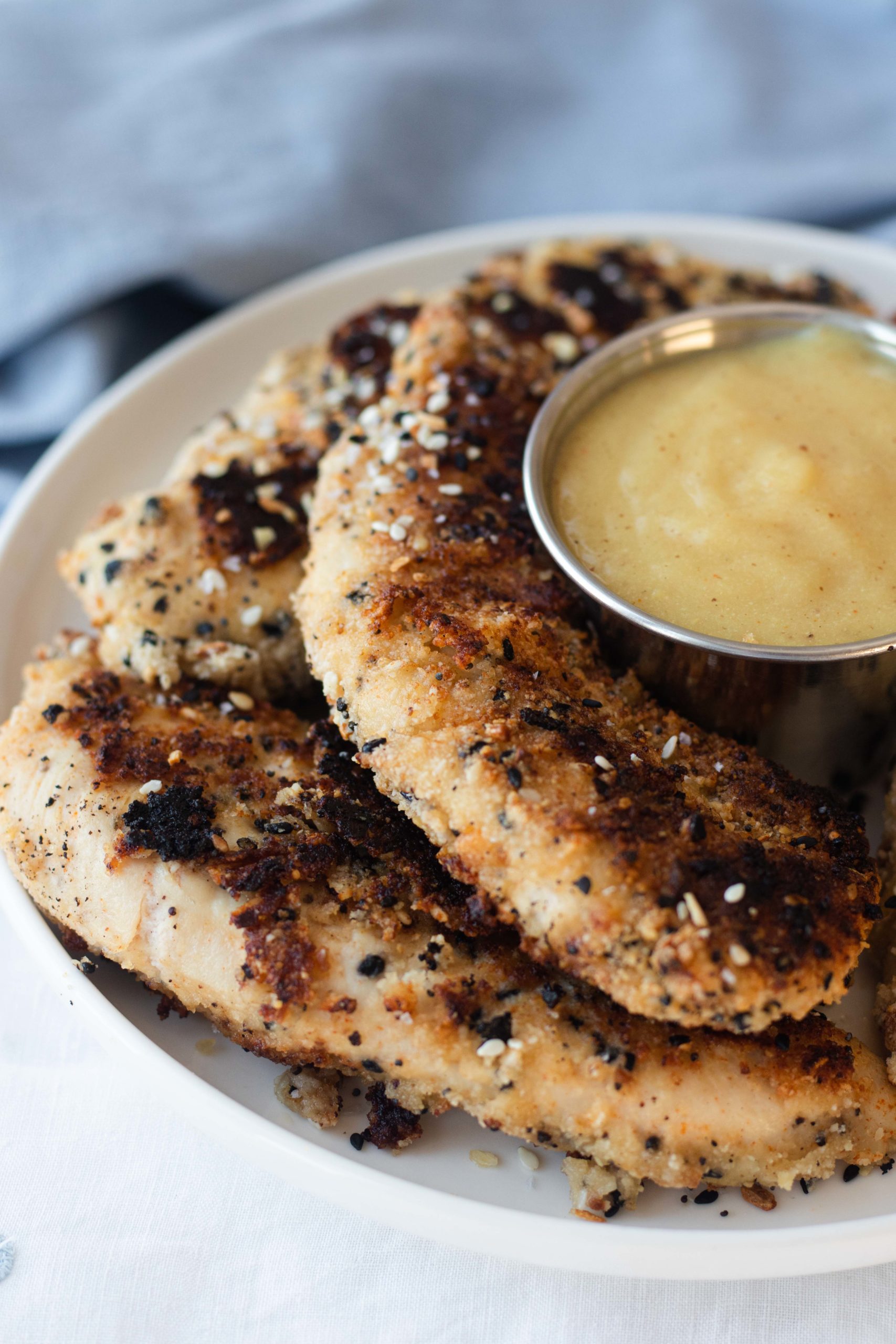 These savory keto chicken strips are breading an almond flour coating that is seasoned well with everything bagel seasoning. Great on salads and wraps!