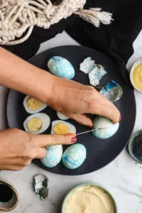 Halloween devilled eggs cutting eggs